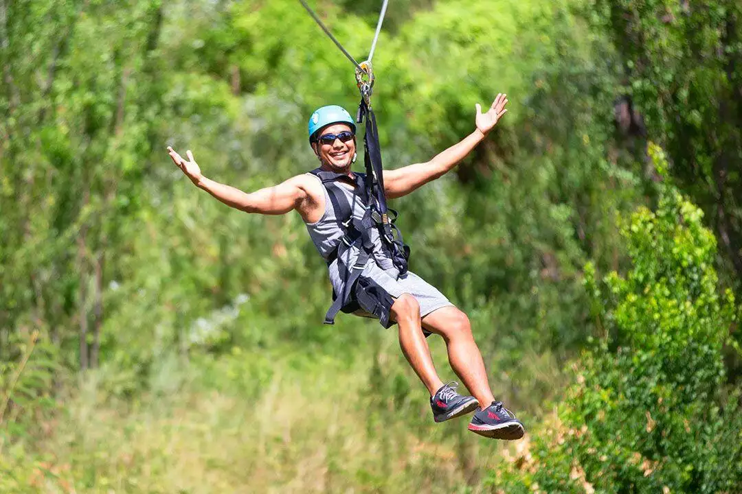 a man ziplining at Coral Crater